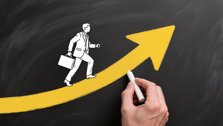 Businessman drawing a graph on a blackboard with a white chalkの素材