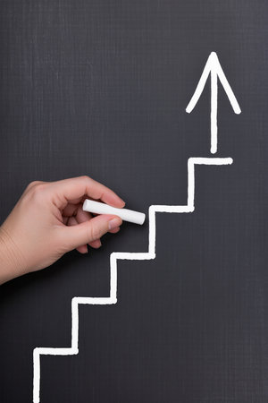 hand drawing a chart on a blackboard with white chalk, success conceptの素材