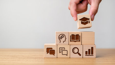 Concept of education and learning with icons on wooden cubes over white backgroundの素材