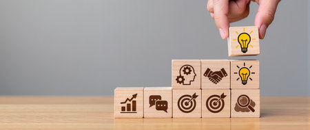 Wooden blocks with icons of business, finance and technology concept.の素材