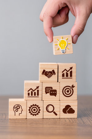 Wooden blocks with icons of business, technology, internet and networking concept.の素材