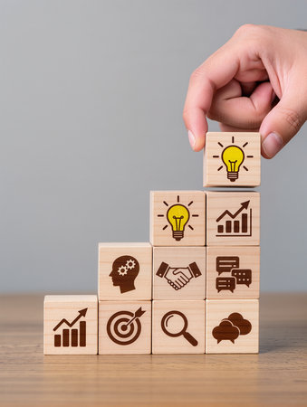 Businessman hand arranging wood block stacking as step stair with light bulb, cloud computing, social media marketing and innovation icons on wooden table, business success conceptの素材