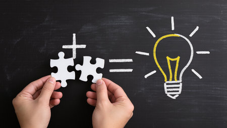 Idea concept with light bulb and puzzle piece on blackboard backgroundの素材