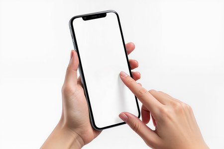 Female hands holding a smartphone with a blank screen on a white backgroundの素材