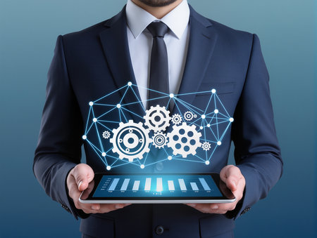 businessman with tablet pc and gear on blue background, close upの素材