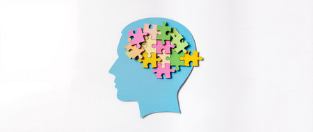Silhouette of a human head with puzzle pieces in it on white backgroundの素材