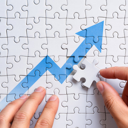 Close up of businesswoman completing jigsaw puzzle with upward arrow symbolの素材