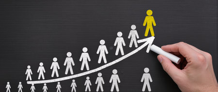 Hand drawing a chart on blackboard with a marker, business conceptの素材