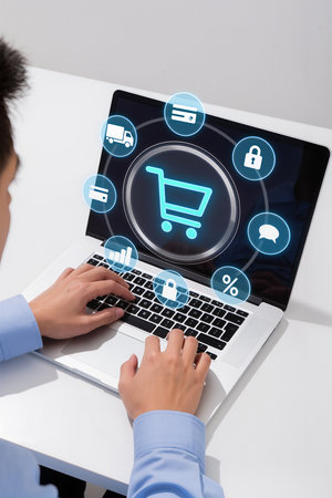 businesswoman using laptop with shopping cart icon on screen over grey backgroundの素材