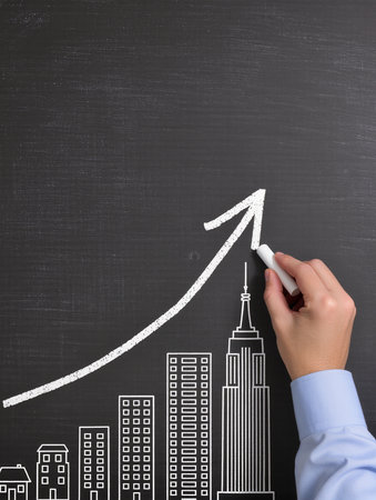 hand drawing a graph on a blackboard, concept of business growthの素材