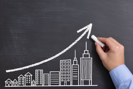 businessman drawing a graph on blackboard, closeup of photoの素材