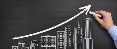 Hand drawing a growing graph with chalk on blackboard. Business conceptの素材