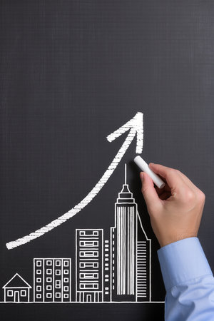 hand drawing a graph on a blackboard, concept of financial growthの素材