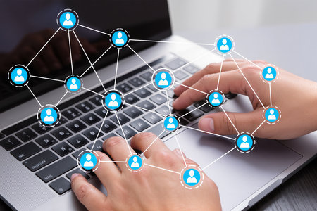 Social media concept. Businessman working with laptop and social network diagramの素材