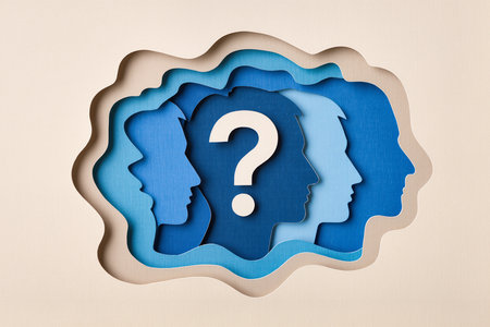 Paper cut human head and question mark on paper background. FAQ conceptの素材