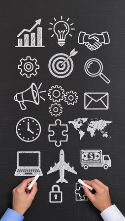 business, education and office concept - close up of businesswoman drawing strategy on blackboardの素材