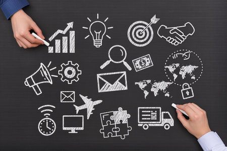 businessman hand drawing business strategy on blackboard, success and strategy conceptの素材