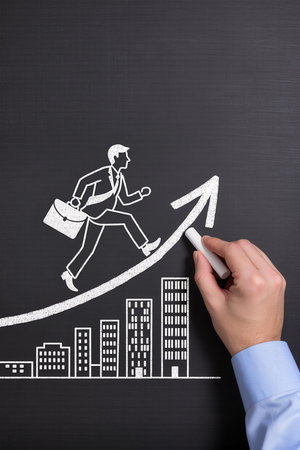 Businessman drawing a graph on blackboard, concept of business successの素材
