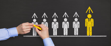 Businessman drawing a graph on a blackboard with a yellow markerの素材