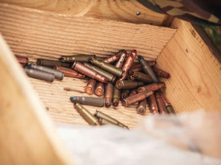 Close up shot of a lot of bullets in a wodden boxの写真素材