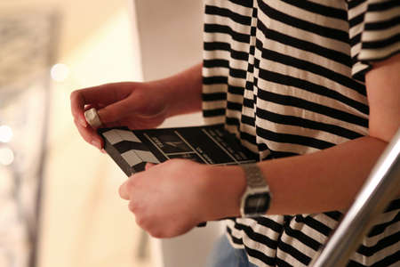 woman's hands holding a clapperboard. Studio shotの写真素材