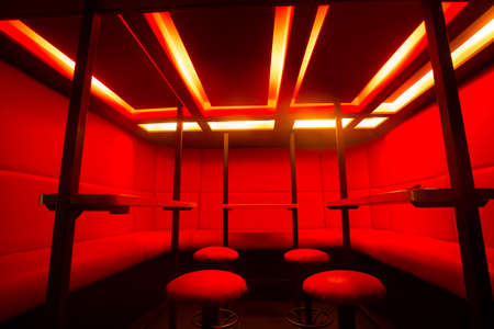 Red bar stools at diode color light.