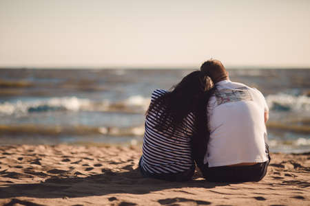Tender loving couple sitting on the beach.の写真素材