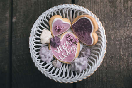 From above view of romantic composition of white candles with various sweet cookies on wooden surface.の写真素材