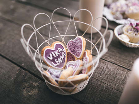 From above view of romantic composition of white candles with various sweet cookies on wooden surface.の写真素材
