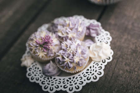 From above view of romantic composition of white candles with various sweet cookies on wooden surface.の写真素材