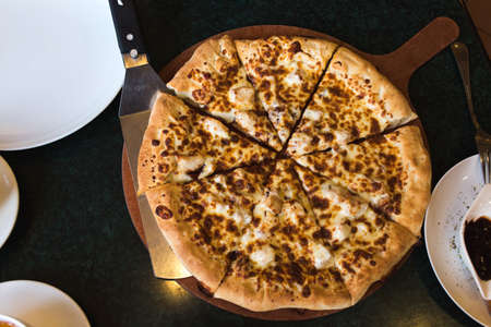 four cheese pizza with ingredients in cafe.の写真素材