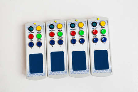 View from above at four control panels of digital display, lies in a row isolated on white backgroundの写真素材