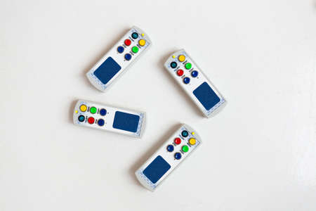 View from above at four control panels of digital display, lies in a row isolated on white...