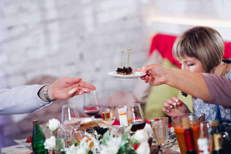 Hands of unrecognizable people clinking glasses with champagne on event.の写真素材