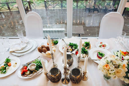 Wonderful magical interior of table for newlyweds table in rustic style with natural decor.の写真素材