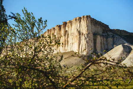 View of White rock or Aq Qaya on a Sunny summer day. Crimea. White limestone with a vertical cliff.