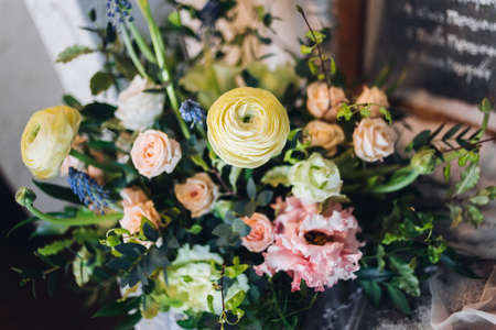 Beautiful composition with flowers on the tables and candles for guests at a wedding or a birthday...