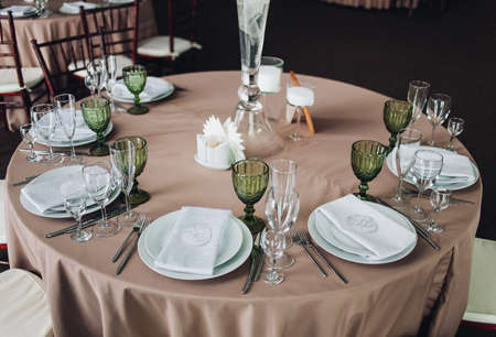 Beautiful composition with flowers on the tables and candles for guests at a wedding or a birthday party.の写真素材
