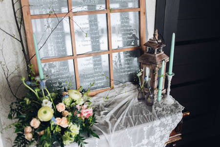 Beautiful composition with flowers on the tables and candles for guests at a wedding or a birthday...