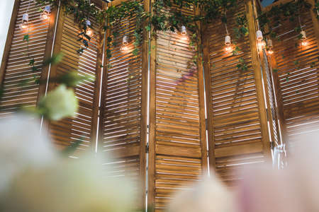 Beautiful composition with flowers on the tables and candles for guests at a wedding or a birthday party.の写真素材