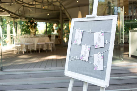 Beautiful composition with flowers on the tables and candles for guests at a wedding or a birthday...