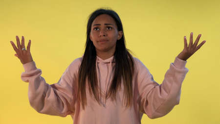 Young black woman is very upset how it could have happened. She shooting herself in the head with finger gun gesture and then falling down.の写真素材