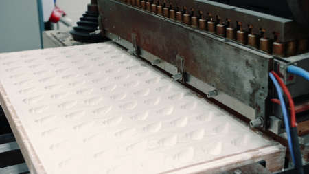 Industrial machine making candies. Modern industrial machine making delicious candies in...
