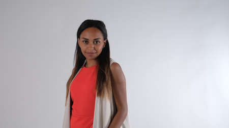 Pretty black model working on camera in fashion studio. She smiling and changing poses.の写真素材