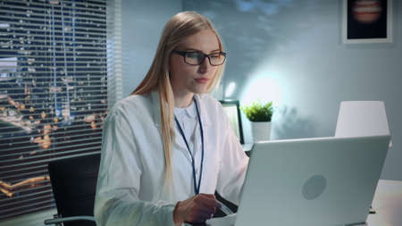 Middle close-up of professional psychologist making therapy session online by video call on...
