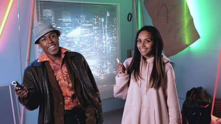 African male and female film stars smiling to the camera. Man showing his fun.の写真素材