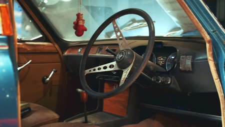 View of dashboard panel and steering wheel of antique car Triumph. Old interior. Warsaw, Poland - July 10, 2019のeditorial素材