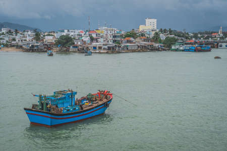 Fishing Boat At Anchor Off Poor Village In Nha Trang. Vietnamの写真素材