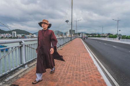 A man walks over a bridge in Vietnam, Asia. Nha Trang, Vietnam - March 15, 2020.