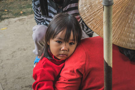 A little Vietnamese girl from the ethnic group poses the foreigner for the camera. Hue, Vietnam - March 8, 2020.のeditorial素材